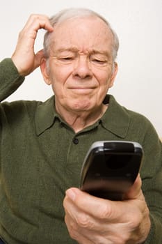 Confused elderly man with remote control