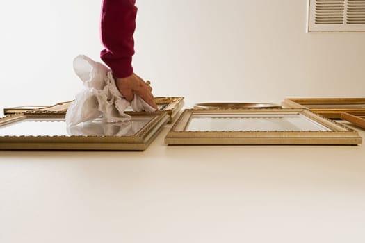 Woman dusting picture frames