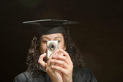 Female graduate taking a photograph