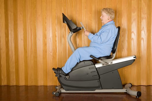 Senior woman on an exercise bike