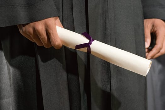 Graduate holding diploma