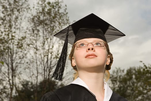 Female graduate looking up