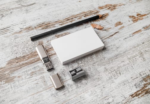Bank white business cards, pencil, flash drive and sharpener on vintage wood table background. Mock-up for branding identity. Blank template for design presentations and portfolios.