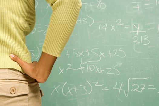 Female student stood in front of blackboard
