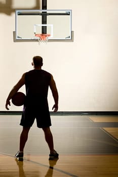 Basketball player alone in basketball court