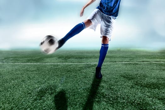 Athlete kicking soccer ball