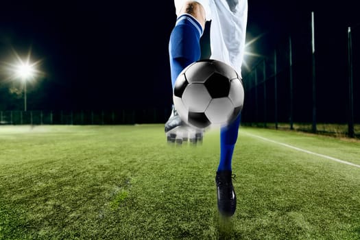 Athlete kicking soccer ball