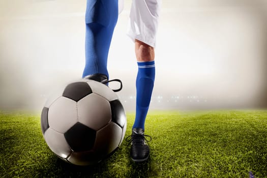 Athlete kicking soccer ball