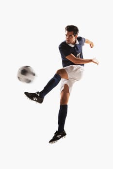 Soccer player kicking soccer ball