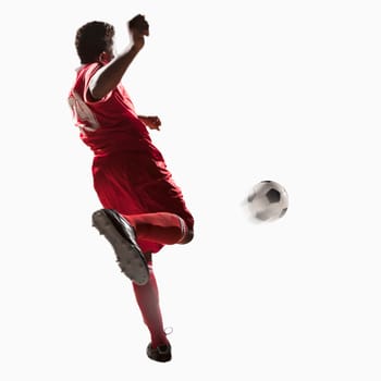 Soccer player kicking soccer ball