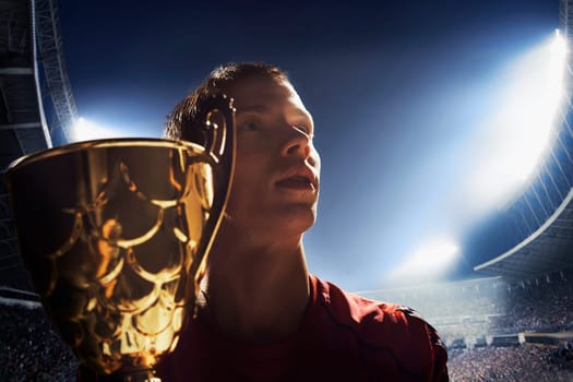 Athlete cheering with trophy cup