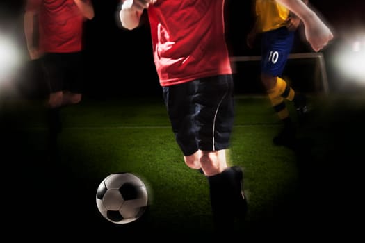 Soccer player kicking soccer ball
