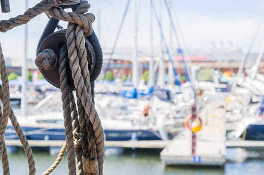 Rigging on the old sailboat against the background of modern yachts