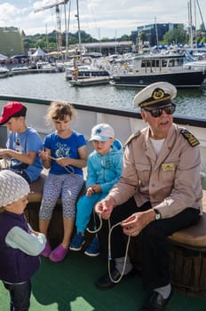 TALLINN, ESTONIA - JULY 19: Experienced sailor shows how to knit knots at the Days of the Sea in Tallinn, Estonia on July 19 2015.