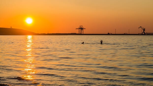 Couple bathing at sunset in the sea
