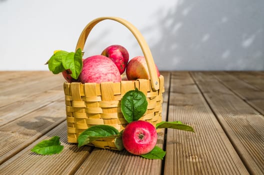 Basket with ripe red apples, close-up
