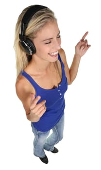 Beautiful young lady dancing and listening to music - isolated