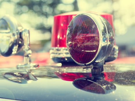 Close up of a vintage fire department car, retro color toned with sun beam