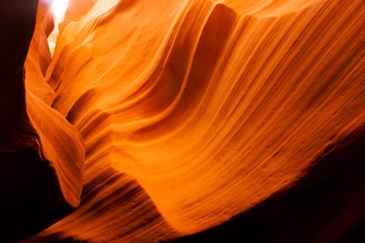 Sandstone takes on even more gold color as light streams in from above
