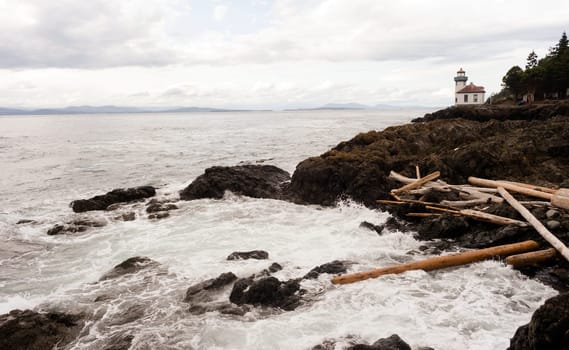 Waves crash up onto the rocks from the Pacific Ocean at this coastal lighthouse