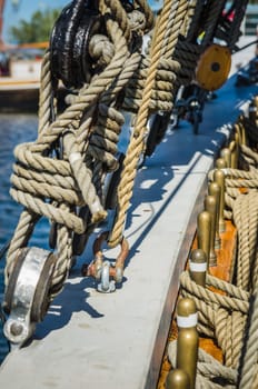 Rigging on the old sailboat against the background of modern yachts