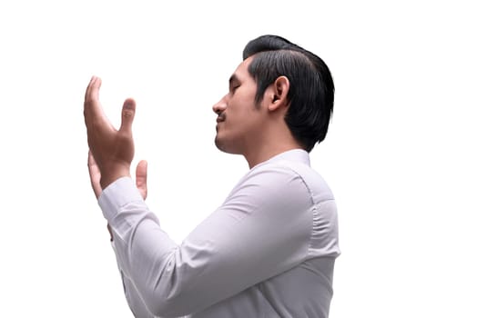 Young asian muslim man raising hand and praying isolated over white background