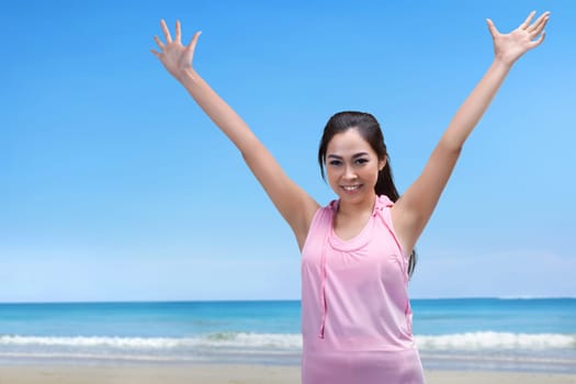 Happy asian athlete woman running exercise on the beach