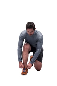 Sporty asian man sit down tying shoelaces ready for running isolated over white background