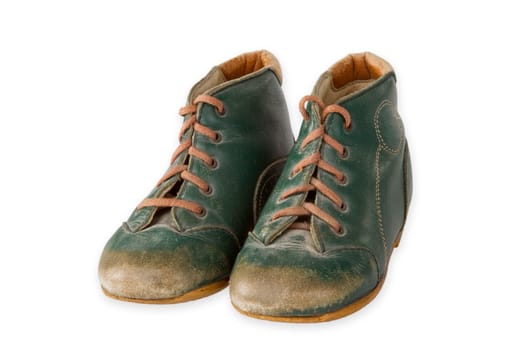 Old baby shoes exposed on a light background