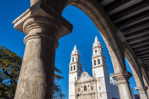 Cathedral in Campeche, Mexico seen through a stone arch