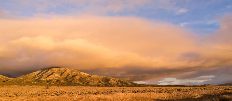 Panoramic Landscape Clouds Over Hillside Sunset Orange Glow