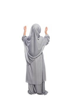 Back view asian muslim girl raising hand and praying isolated over white background