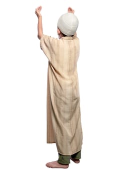Back view of asian muslim kid raising hand and praying isolated over white background