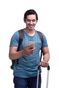 Happy asian male traveler with bags and mobile phone isolated over white background
