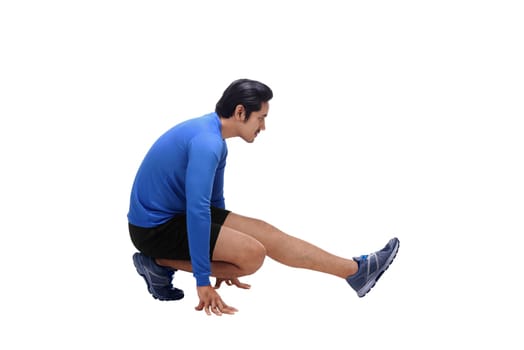 Handsome asian man athlete doing stretching legs before running isolated over white background