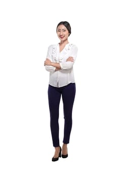 Portrait of a happy asian business woman standing with folded hands isolated over white background