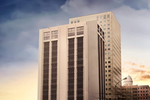 Stylized modern office building architecture in the city at sunset