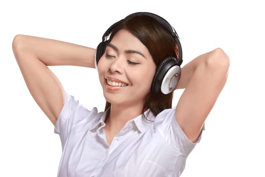 Beautiful asian woman listening music with headphone isolated over white background