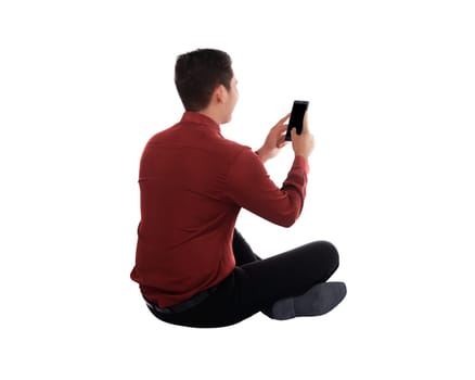 Back view of asian businessman sitting using a smartphone isolated over white background