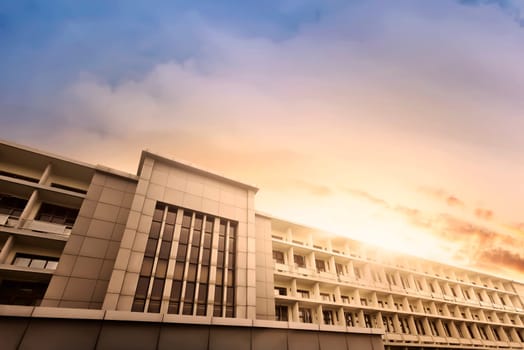 Modern apartment with large building at sunset