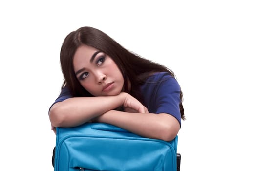 Beautiful asian woman traveler embrace a blue suitcase isolated over white background