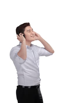 Young asian man listening music with headphone isolated over white background