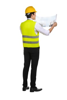 Young asian architect man looking at his blueprints isolated over white background