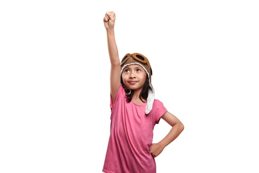 Beautiful asian kid in aviator helmet playing like a pilot isolated over white background