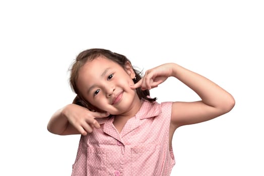Cheerful asian little girl in pink dress with excited expression isolated over white background