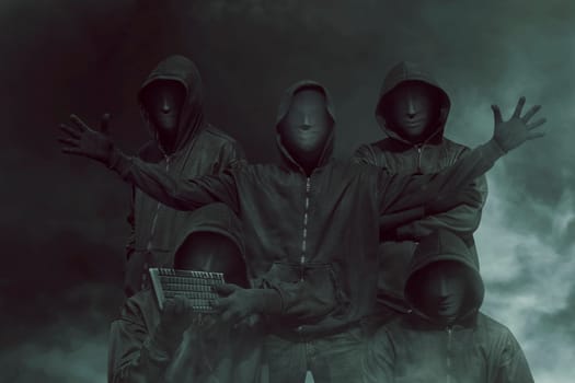 Group of hacker with mask in hoodies against dark background