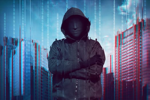 Hooded man wearing guy fawkes mask with binary data system security