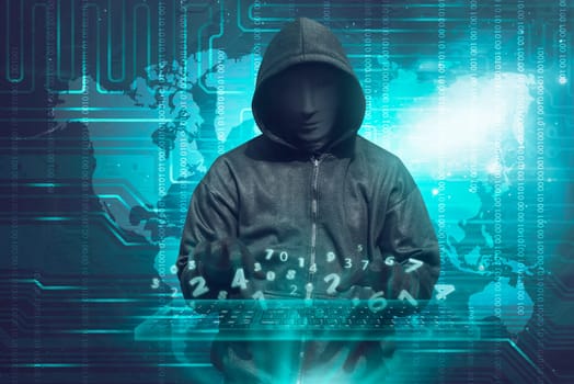 Hacker in mask typing keyboard hacking binary data system security