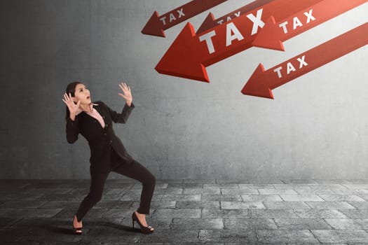 Young asian businesswoman shocked with Tax on arrow going down to her in the street