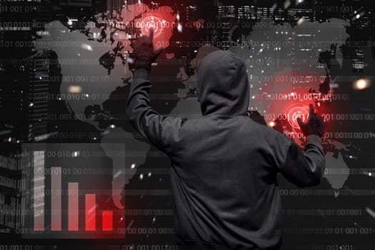 Back view of hooded hacker at work with virtual graphic user interface